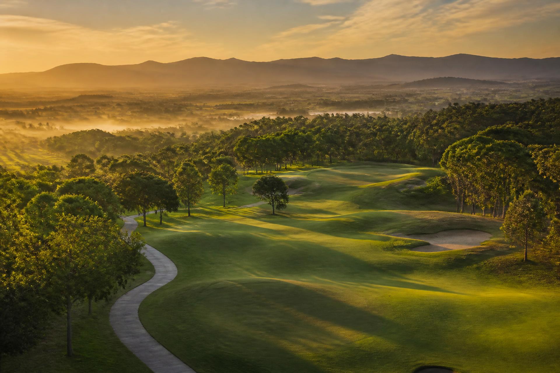 Aerial view of a golf course at golden hour